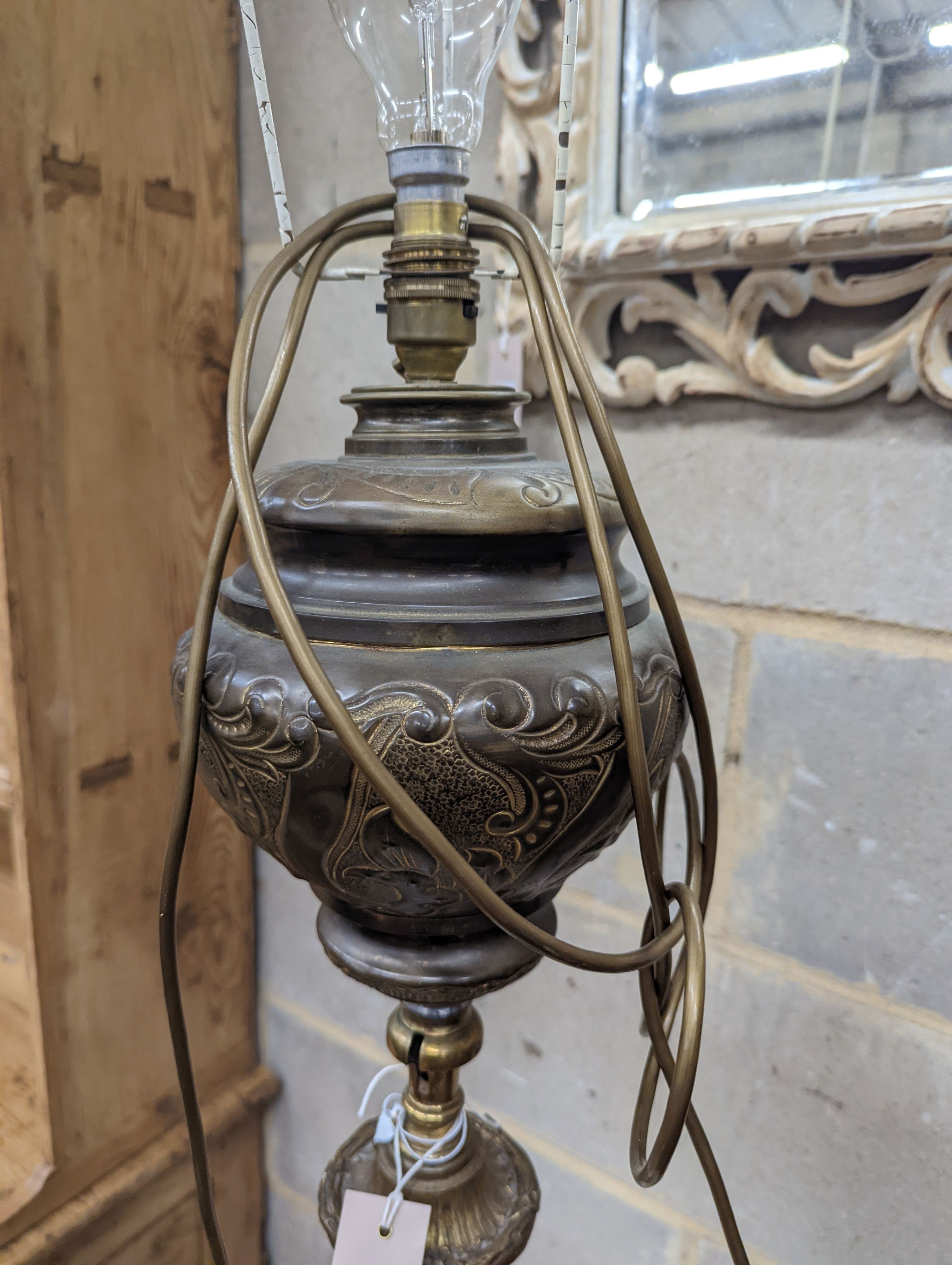 A late Victorian cast brass and onyx oil lamp standard, the column with an alabaster mid tier, raised on an open scrolled tripod base, converted to electricity, height 152cm
